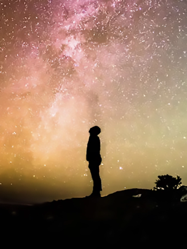 man standing under the cosmos